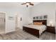 Spacious main bedroom with vaulted ceiling, side tables, and carpeted floors at 1633 S Trenton St, Denver, CO 80231