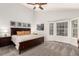 Serene main bedroom with vaulted ceiling, a bay window, and neutral decor at 1633 S Trenton St, Denver, CO 80231