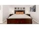 Close up on large bed with dark wood frame in main bedroom at 1633 S Trenton St, Denver, CO 80231