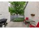 Cozy patio area with greenery and a grill, perfect for outdoor entertaining at 1633 S Trenton St, Denver, CO 80231