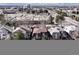 Aerial view of townhomes neighborhood with city skyline and mountain range in the background at 2323 S Jamaica St, Aurora, CO 80014