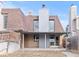 Backyard view featuring a partially covered patio and access to the home's back entrance at 2323 S Jamaica St, Aurora, CO 80014