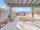 View of backyard with covered patio and path leading to detached garage at 2323 S Jamaica St, Aurora, CO 80014