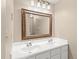 Bathroom with double vanity, large mirror, and modern lighting at 2323 S Jamaica St, Aurora, CO 80014