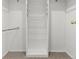 Spacious closet featuring built-in shelves and hanging rods for ample storage space at 2323 S Jamaica St, Aurora, CO 80014