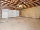 Spacious garage featuring a large door, overhead lighting, and ample room for parking at 2323 S Jamaica St, Aurora, CO 80014