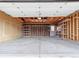 Interior of the unfinished garage showcasing space, shelving, and construction at 2323 S Jamaica St, Aurora, CO 80014