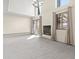 Bright, open living room with fireplace, sliding door to the outdoor, neutral carpet, and stylish chandelier at 2323 S Jamaica St, Aurora, CO 80014