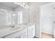 Bright bathroom with double sinks and shower enclosure at 19733 W 93Rd Ln # A, Arvada, CO 80007