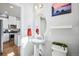 Charming powder room with pedestal sink and adjacent kitchen access at 19733 W 93Rd Ln # A, Arvada, CO 80007