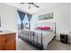 Stylish bedroom with large windows offering neighborhood views and a ceiling fan at 19733 W 93Rd Ln # A, Arvada, CO 80007