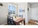 Cozy dining area featuring a wooden table, black chairs, and a large window at 19733 W 93Rd Ln # A, Arvada, CO 80007