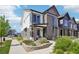 Charming two-story townhome with stone accents, landscaped front yard, and inviting entrance at 19733 W 93Rd Ln # A, Arvada, CO 80007
