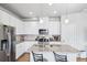 Bright kitchen with stainless steel appliances, granite countertops, and white cabinets at 19733 W 93Rd Ln # A, Arvada, CO 80007