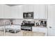 Bright, modern kitchen with granite countertops, stainless steel appliances, and sleek white cabinetry at 19733 W 93Rd Ln # A, Arvada, CO 80007