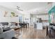 Bright open-concept living room with wood floors, a ceiling fan, and views of the outdoors at 19733 W 93Rd Ln # A, Arvada, CO 80007