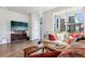 Comfortable living room featuring hardwood floors, a TV, and a large window at 19733 W 93Rd Ln # A, Arvada, CO 80007