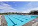 Outdoor swimming pool with multiple lanes and lounge seating for community enjoyment at 19733 W 93Rd Ln # A, Arvada, CO 80007