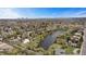 Aerial shot featuring a neighborhood pond, mature trees and the city skyline in the distance at 5503 W Colorado Ave, Lakewood, CO 80232