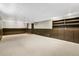 Finished basement features neutral carpet, brown accent walls, and built-in storage at 5503 W Colorado Ave, Lakewood, CO 80232