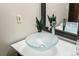 Close-up of a modern bathroom with a glass vessel sink and stylish faucet at 5503 W Colorado Ave, Lakewood, CO 80232
