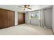 Neutral bedroom featuring carpet, a ceiling fan, large closet and a window with curtains at 5503 W Colorado Ave, Lakewood, CO 80232