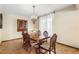 Traditional dining room featuring a wood table, cabinet, and decorative chandelier at 5503 W Colorado Ave, Lakewood, CO 80232