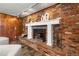 Close-up of a charming brick fireplace with a white mantel and decorative accents at 5503 W Colorado Ave, Lakewood, CO 80232