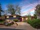 Charming split-level home with a manicured front yard, brick and siding exterior, and a lovely purple front door at 5503 W Colorado Ave, Lakewood, CO 80232