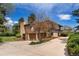 View of the side of the property showing the garage, mature trees, and professional landscaping at 5503 W Colorado Ave, Lakewood, CO 80232