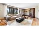 Comfortable living room with plush seating, large windows, and access to a hallway at 5503 W Colorado Ave, Lakewood, CO 80232