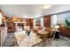Cozy living room boasts a brick fireplace, plush seating, and ample natural light at 5503 W Colorado Ave, Lakewood, CO 80232