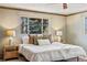 Bright bedroom with a large window, plush pillows, and stylish bedside tables at 5503 W Colorado Ave, Lakewood, CO 80232