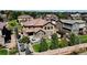 Beautiful aerial view of a home showcasing a spacious backyard, manicured lawns, stone patio, and lush landscaping at 1440 Eversole Dr, Broomfield, CO 80023