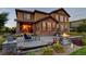 Inviting backyard showcasing a stone patio with a water feature, fire pit, outdoor furniture, and lush landscaping at 1440 Eversole Dr, Broomfield, CO 80023