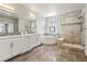 Modern bathroom featuring a soaking tub, a walk-in shower, and double vanity sinks at 1440 Eversole Dr, Broomfield, CO 80023