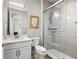 Bathroom featuring a modern shower, toilet and vanity with a white cabinet at 1440 Eversole Dr, Broomfield, CO 80023