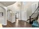 Welcoming foyer with hardwood floors, staircase, and stylish lighting, offering a grand entrance at 1440 Eversole Dr, Broomfield, CO 80023