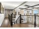 Upstairs hallway and grand staircase showcasing the open floor plan of the home at 1440 Eversole Dr, Broomfield, CO 80023