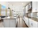 Modern kitchen featuring a center island with granite countertops, stainless steel appliances, and stylish fixtures at 1440 Eversole Dr, Broomfield, CO 80023