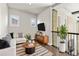 Cozy living room featuring a white couch, stylish rug, wooden table and TV on wall at 1440 Eversole Dr, Broomfield, CO 80023