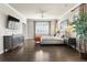 Bright main bedroom showcasing hardwood floors, a large bed, dresser and an abundance of natural light at 1440 Eversole Dr, Broomfield, CO 80023