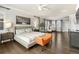 Spacious main bedroom filled with natural light, a king-sized bed, modern furniture, and hardwood floors at 1440 Eversole Dr, Broomfield, CO 80023