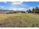 View of expansive backyard with well-kept grass, detached garage and fenced perimeter at 7892 Beverly Blvd, Castle Pines, CO 80108