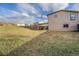 The large backyard with an area that has an attached carport at 7892 Beverly Blvd, Castle Pines, CO 80108