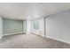 Spacious basement area with neutral carpet, a window for natural light and finished walls at 7892 Beverly Blvd, Castle Pines, CO 80108