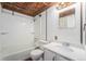 Bathroom with a decorative metal ceiling, vanity, and tub/shower combination at 7892 Beverly Blvd, Castle Pines, CO 80108