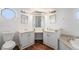 Well-lit bathroom featuring dual vanities, modern fixtures, and tile flooring at 7892 Beverly Blvd, Castle Pines, CO 80108