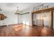 Inviting living room featuring hardwood floors, rustic beam accents, and warm lighting fixtures at 7892 Beverly Blvd, Castle Pines, CO 80108