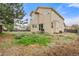 Back of tan two-story house with an unfinished backyard at 1261 E 135Th Pl, Thornton, CO 80241